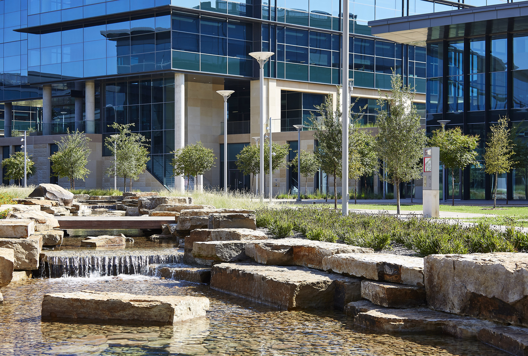 Water and stones in front of a glass facade