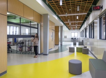 Interior photo of Chandler ISD with a teacher lifting open a classroom door
