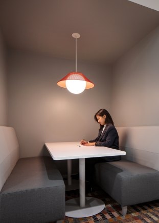 A woman working in a booth at SK Battery's HQ