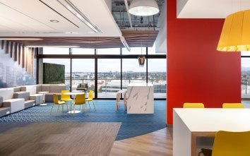 Corgan LA interior with a large yellow light fixture near a bright red wall