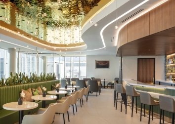 CLT Hospitality Lounge filled with upscale seating and a bar