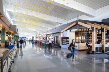 PHX Sky Blossoms hang over passengers walking through the terminal